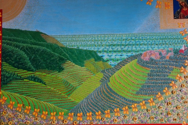 A painting depicting a terraced hillside of the Cinque Terre region. The sun and the Virgin Mary look down on the Garden of Eden. 