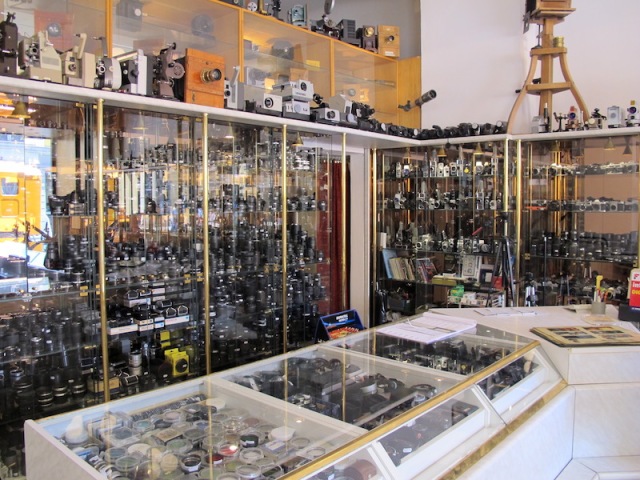Showcases full of lenses, filters, cameras, slide and film projectors. 