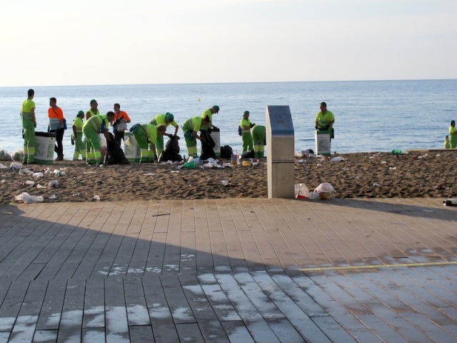 A few of the hundreds of council workers cleaning up after the Barceloneta Beach party.